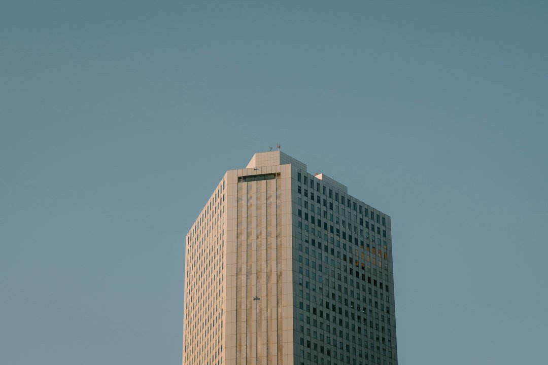 Modern glass office tower against the sky